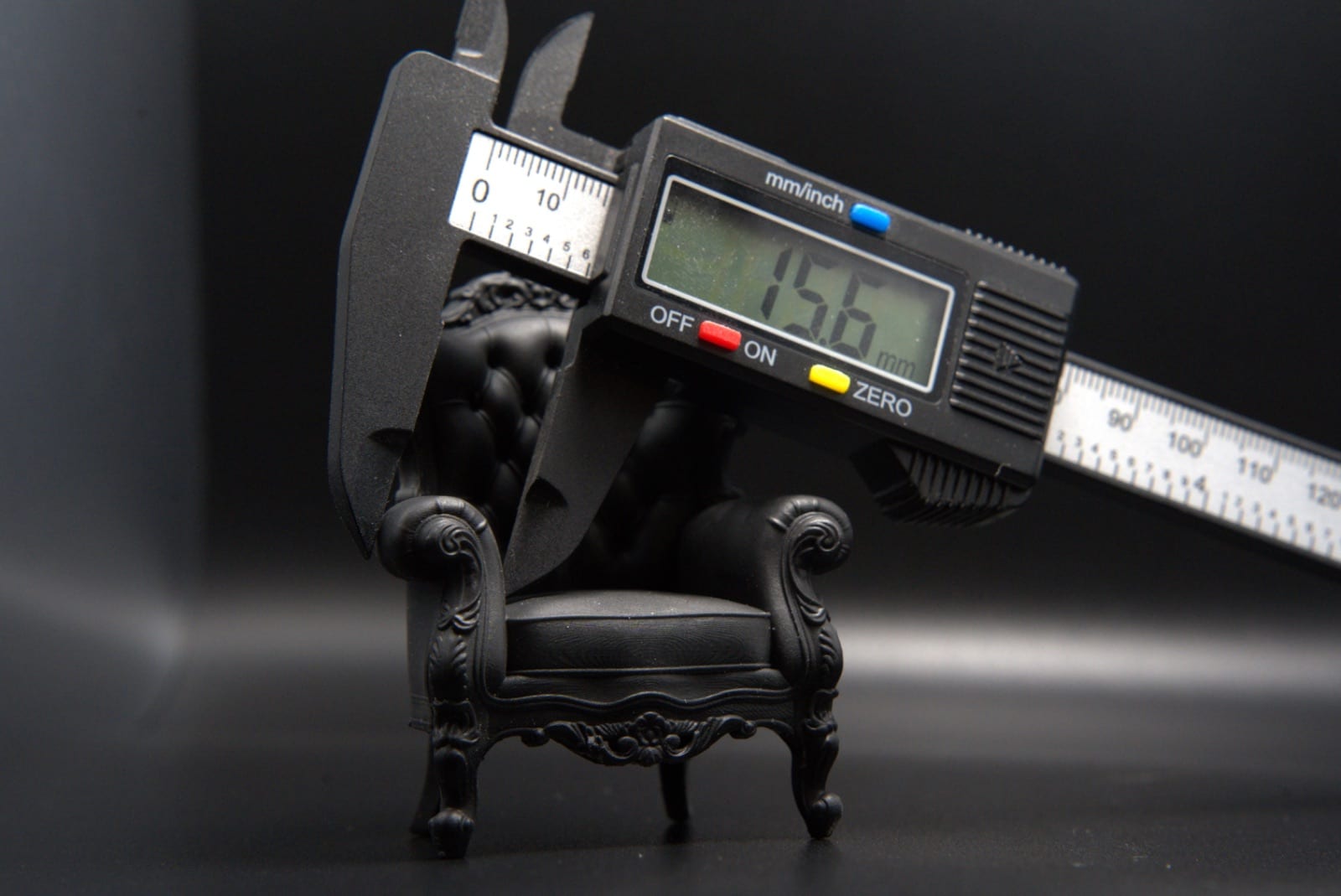 Digital calipers measuring the miniature armchair before shipping