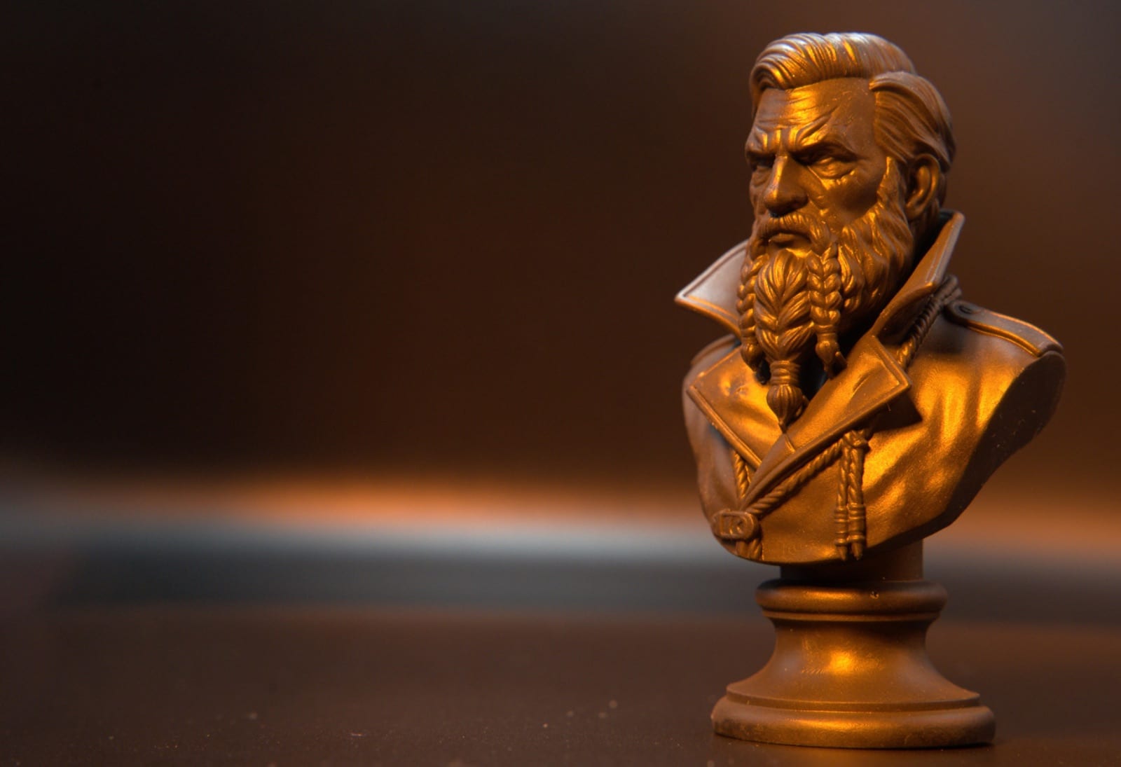 Macro photo of a resin character bust with braided beard detail under raking light
