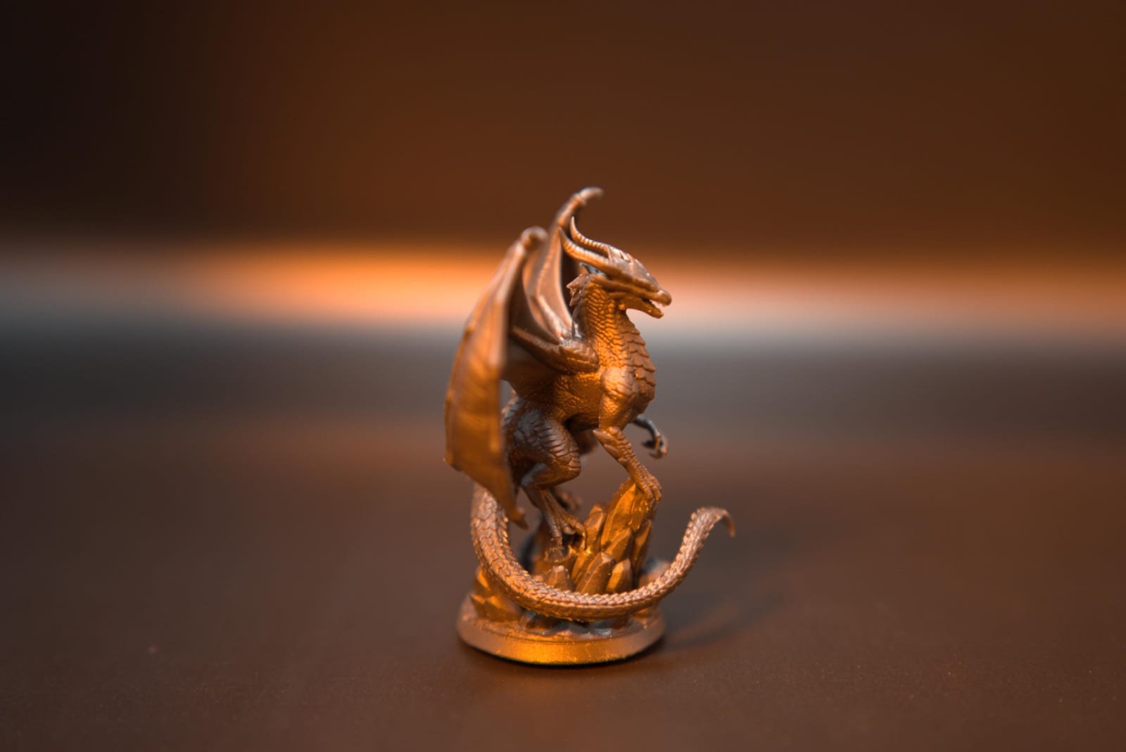 Side profile of the resin dragon miniature showing its wing membranes